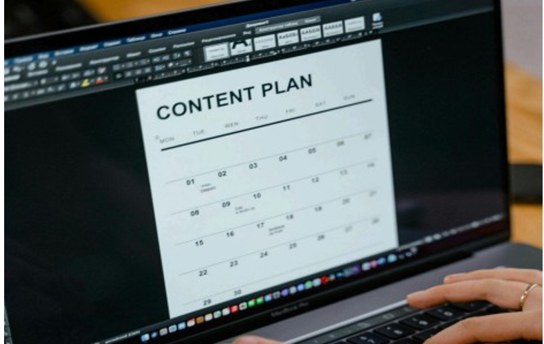 Desktop screen and spreadsheet showing a monthly social media content calendar with columns for date, platform, and status.