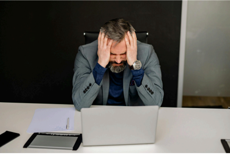 Frustrated marketer reviewing low-performing ad metrics, representing common Snapchat campaign mistakes and optimization challenges.