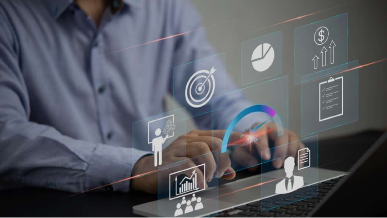 A man working on a laptop displaying icons, representing Scalecode's PPC solution build framework.