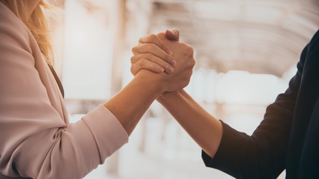 Two business professionals shaking hands, symbolizing partnership and collaboration at ScaleCode Advantage in Bangalore.
